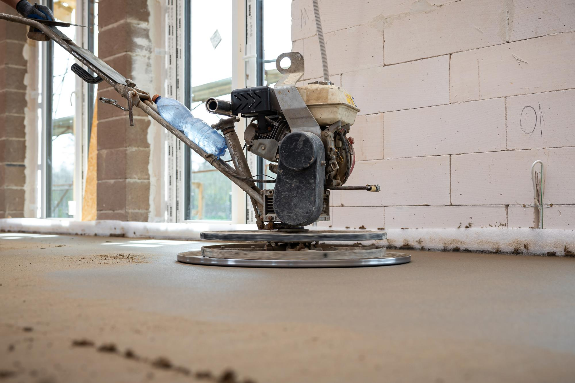 Concrete finishing machine smoothing fresh slab – Concrete Pro Dallas